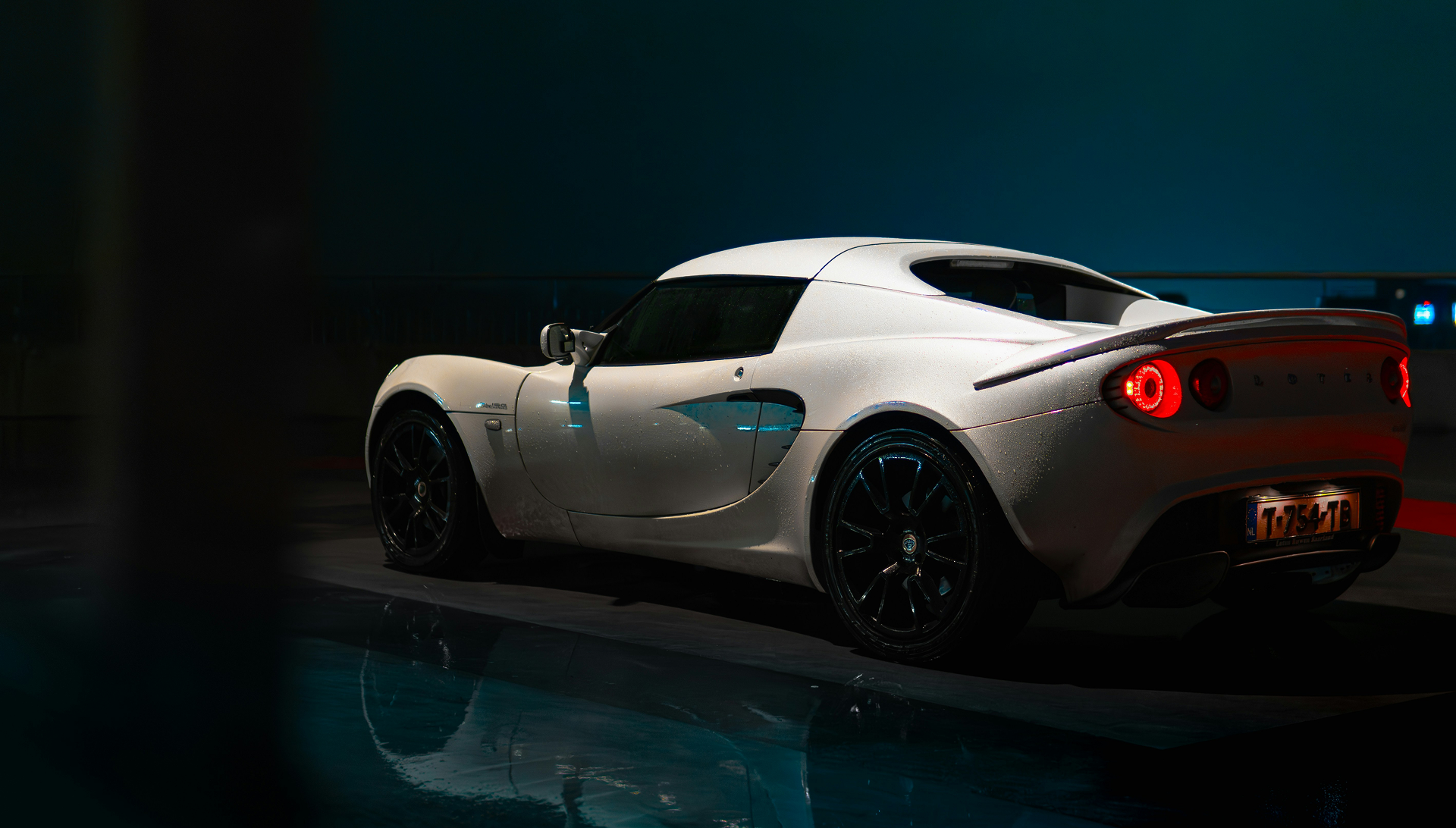 White sports car in a dark garage